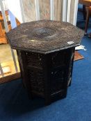 A carved octagonal Benares style occasional table