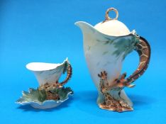 A Franz giraffe tea cup and saucer and matching tea pot (boxed)