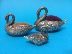 A matched group of three graduating silver swan pin cushions, the largest Adie and Lovekin Ltd,