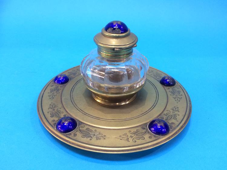 A Victorian cut glass and brass ink well mounted with blue enamelled cabochons