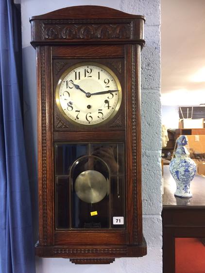 An oak cased wall clock