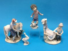 Three Lladro figure groups and a Nao figure group (4)