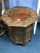 A carved octagonal Benares style table