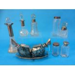 A collection of various silver rimmed and topped scent bottles etc.