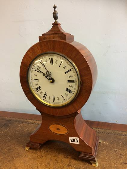 A reproduction mahogany balloon clock