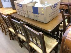 An oak refectory table and six rush seated dining chairs