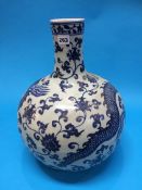 A large Oriental blue and white vase decorated with a dragon