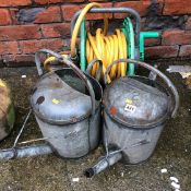 Watering cans and a hose