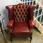 An Oxblood leather Chesterfield high back armchair