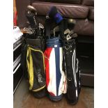 Three sets of golf clubs