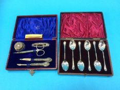 A cased set of six silver spoons and a silver mounted vanity set