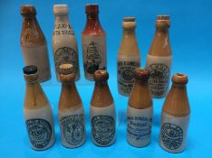 Ten stoneware advertising bottles