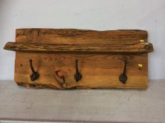 A rustic plank coat rack