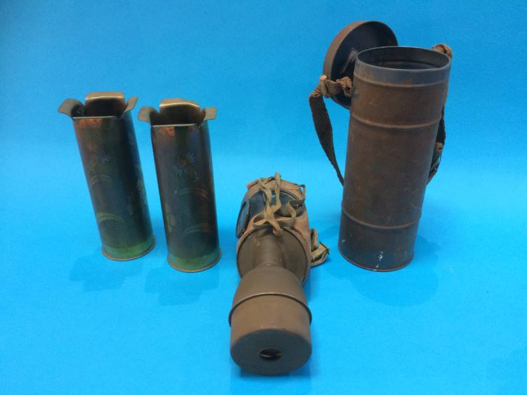Two engraved shell cases and a gas mask, boxed