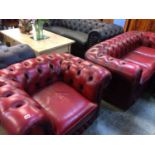An Oxblood Chesterfield settee and matching tub chair