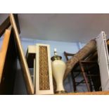 A shelf of assorted including a lamp and a chair