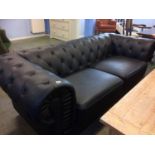 A black Chesterfield settee