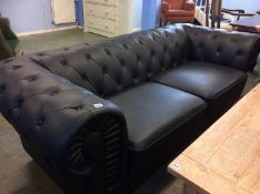 A black Chesterfield settee