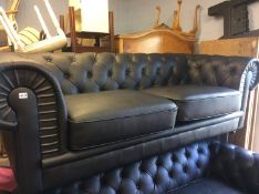 A black Chesterfield settee