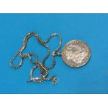 A silver dollar mounted as a pendant