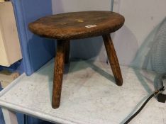 An elm three legged stool