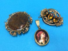 Two brooches in gold coloured mounts and a pendant