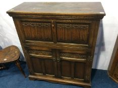 An oak linen fold cocktail cabinet