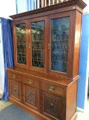 A late 19th century, early 20th century Art Nouveau design three door bookcase, with three leaded