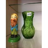 A model of a Walt Disney dwarf and a Whitefriars style green glass vase