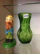 A model of a Walt Disney dwarf and a Whitefriars style green glass vase