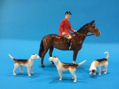 A Beswick Huntsman and three dogs