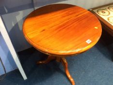 A reproduction mahogany tripod table