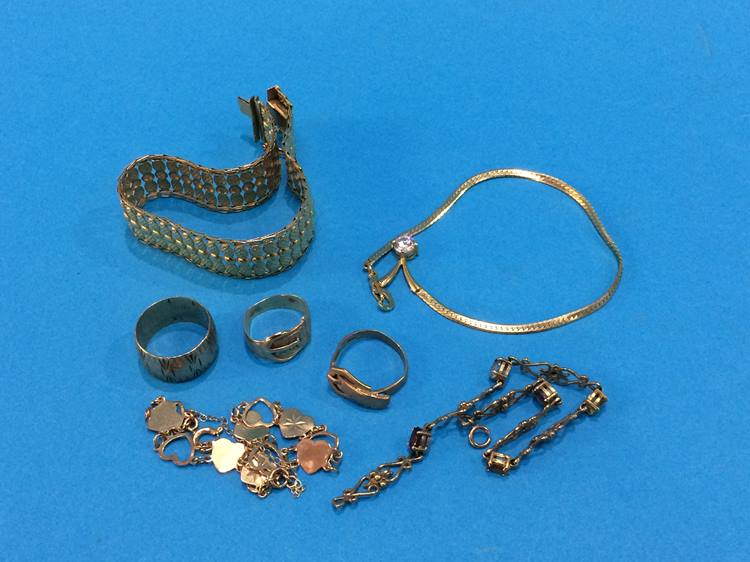 Three 9ct gold rings, two 9ct gold bracelets, another stamped '9kt', 32.1 grams, together with a
