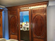 An Edwardian triple door wardrobe