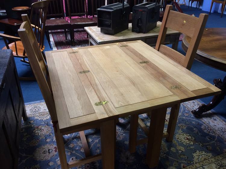 A modern oak extending table and pair of chairs