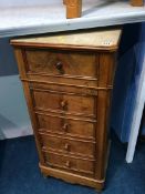 A Continental walnut bed side chest of five drawers, with inset marble top