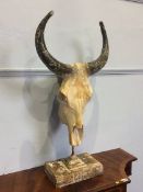 A simulated mounted cow skull