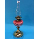 A Victorian oil lamp with pink glass reservoir