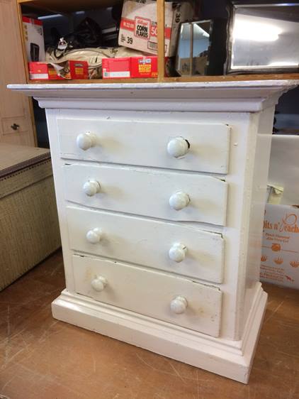 A miniature painted chest of drawers