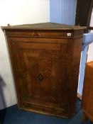 A Georgian hanging oak corner cabinet