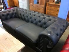 A black Chesterfield settee