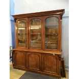 A Victorian mahogany three door bookcase with moulded cornice, three glazed doors below three