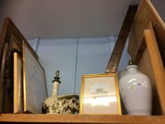 A shelf of pictures, lamps and a fender