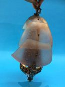 A brass and glass light fitting, in the form of a ships bow