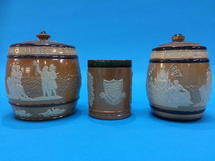 A Doulton stoneware commemorative beaker and two tobacco jars (3)