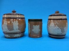 A Doulton stoneware commemorative beaker and two tobacco jars (3)