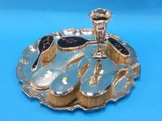 Various silver mounted brushes and mirrors and a silver vase on a plated serving tray