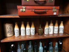 Collection of nine stoneware bottles and one olive glass bottle