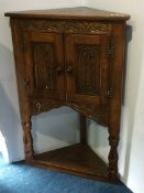 Carved oak standing corner cabinet