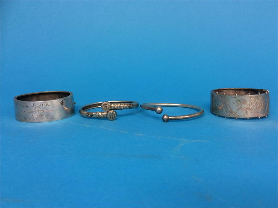 Four various silver coloured bangles